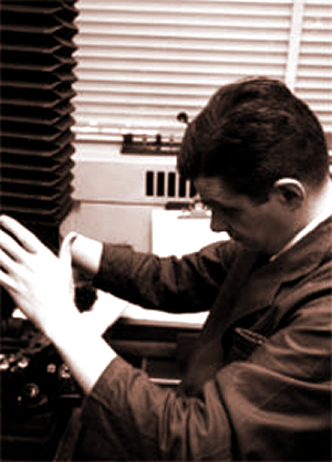 Fox Chase researcher David A. Hungerford prepares a camera to photograph specimens under the microscope. Hungerford discovered the Philadelphia chromosome in 1959.