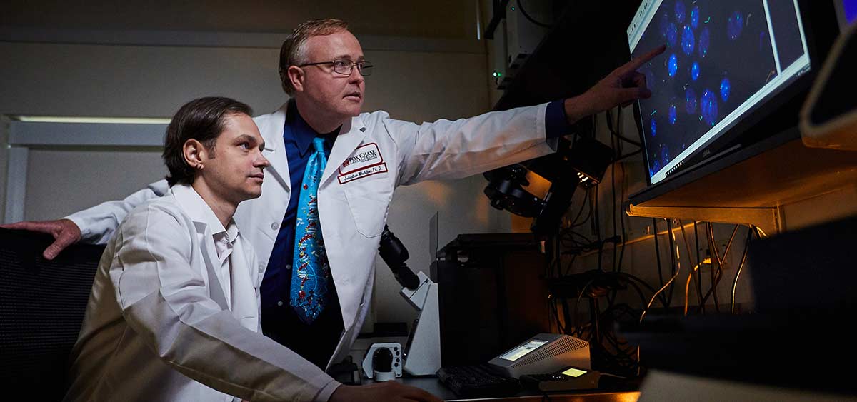 Dr. Johnathan Whetstine and Dmitry Levchenko, MD (seated). The award will allow Whetstine’s lab to follow up on previous work investigating epigenetic factors that control copy number gains, which contribute to heterogeneity within lung tumors.  The main goal of the new research is to build a network of the regulatory input signals that are influencing heterogeneity through copy number mechanisms.