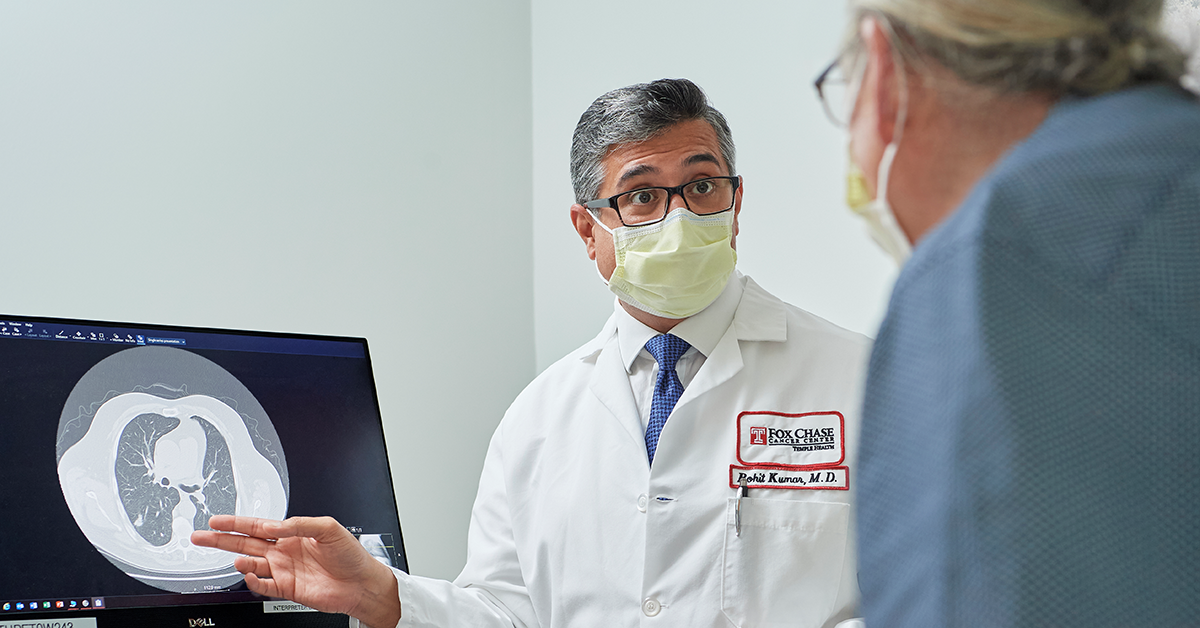 Dr. Rohit Kumar speaks with a patient about their low-dose CT scan results.
