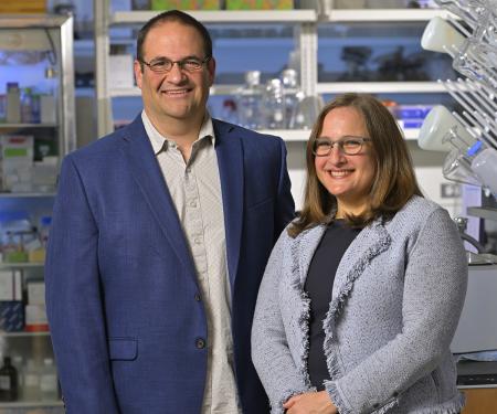 Dr. Philip Abbosh and Dr. Elizabeth Plimack standing in the laboratory and smiling.