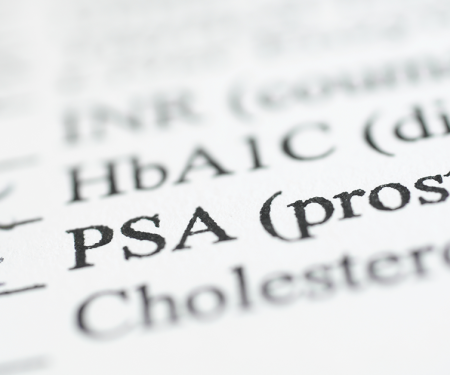 An extremely close photo of a pencil tip against a checklist, marking an X next to where it says "PSA."