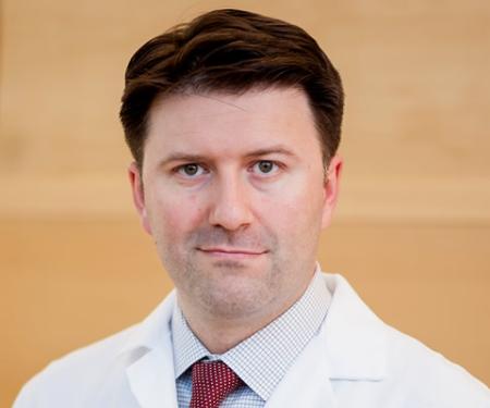 A portrait shot of Dr. Alexander Kutikov, MD, FACS, looking at the camera with a small smile.
